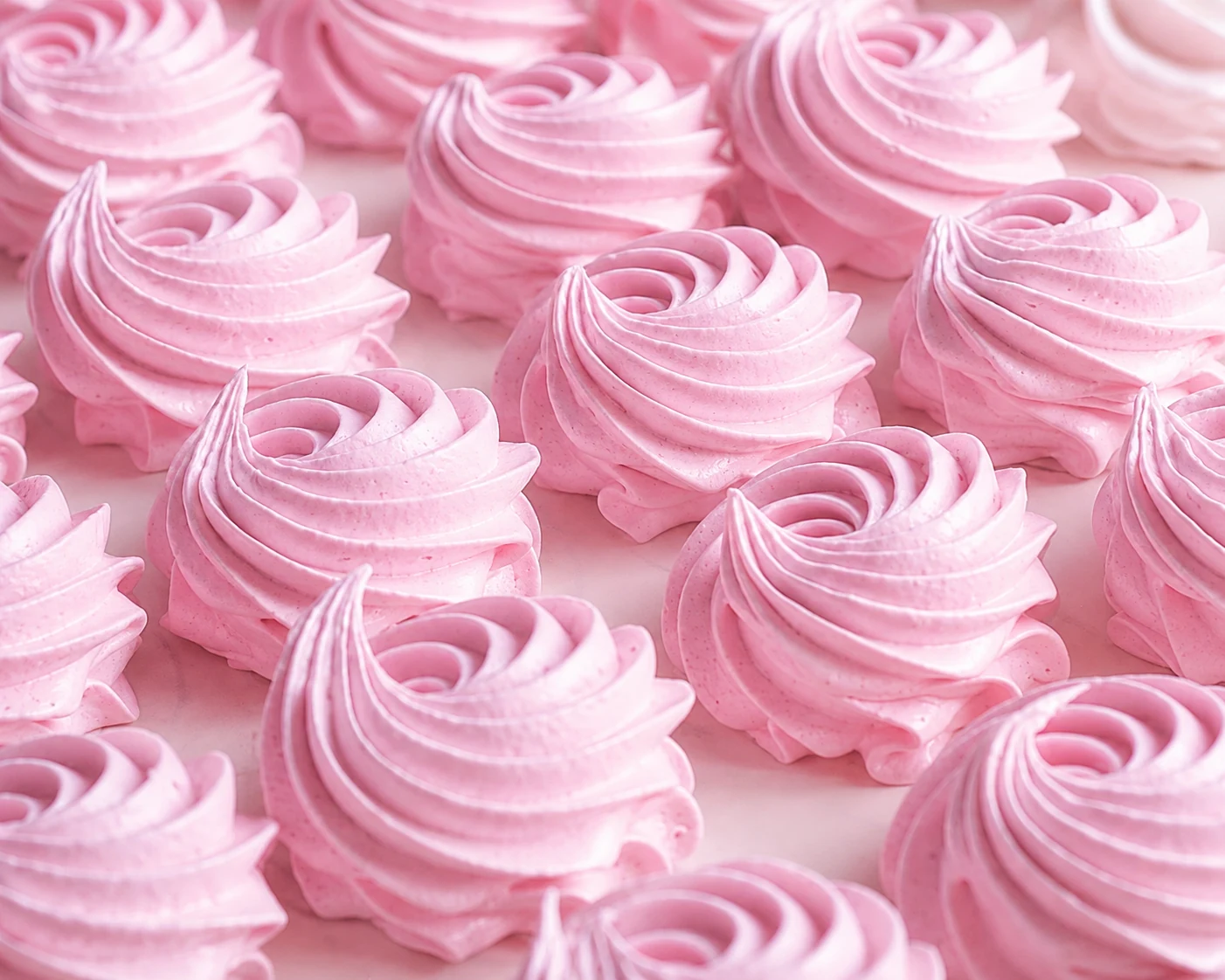 Rows of handmade pink flower-shaped zefir